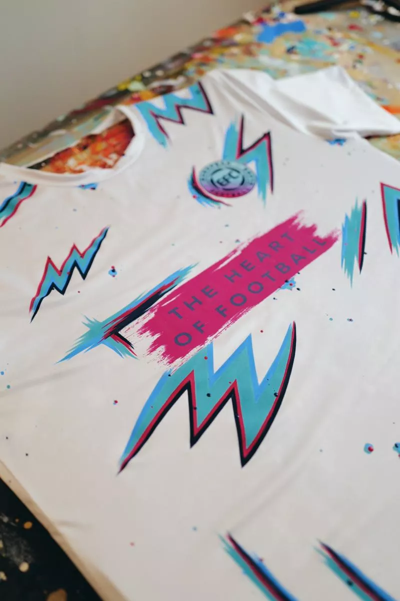 Why does this man paint lightning bolts on football shirts?